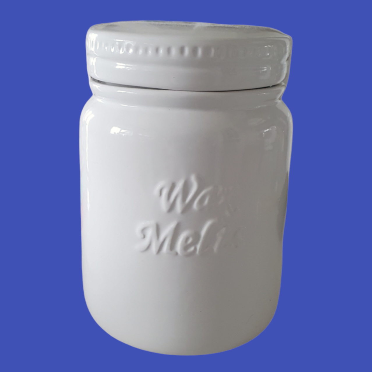 Picture shows a large wax melts storage jar in white ceramic on a blue background