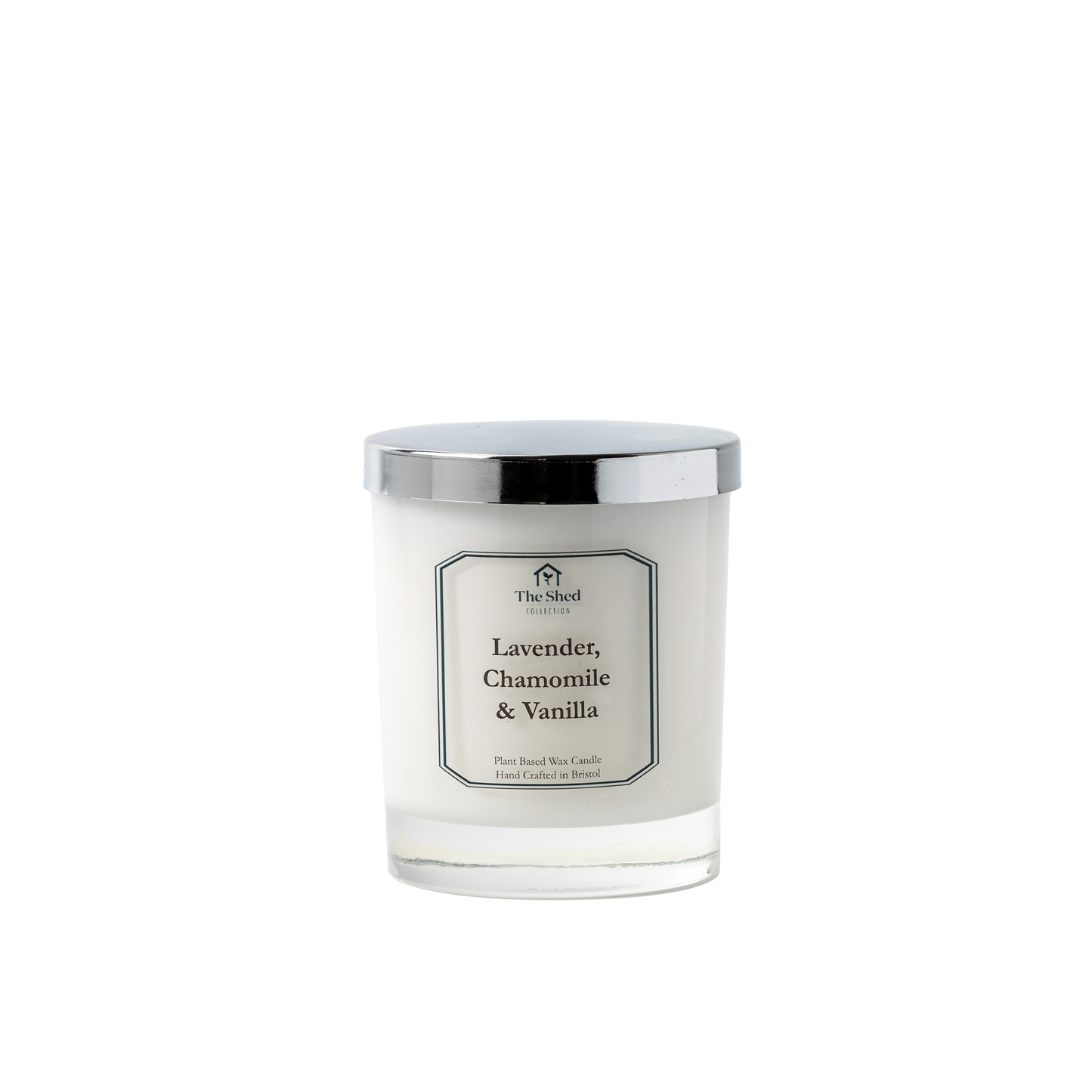 A white candle jar with a silver lid, labeled 'Lavender, Chamomile & Vanilla' by The Shed Collection.