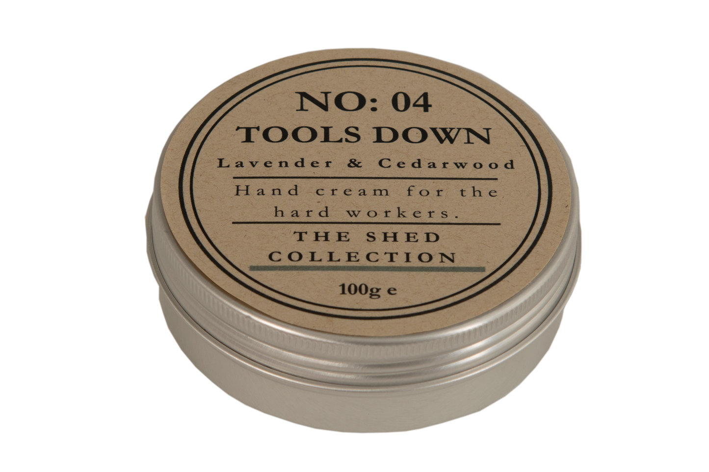 A round metal tin of hand cream with a kraft paper label reading 'NO: 04 TOOLS DOWN Lavender & Cedarwood' and 'THE SHED COLLECTION'.
