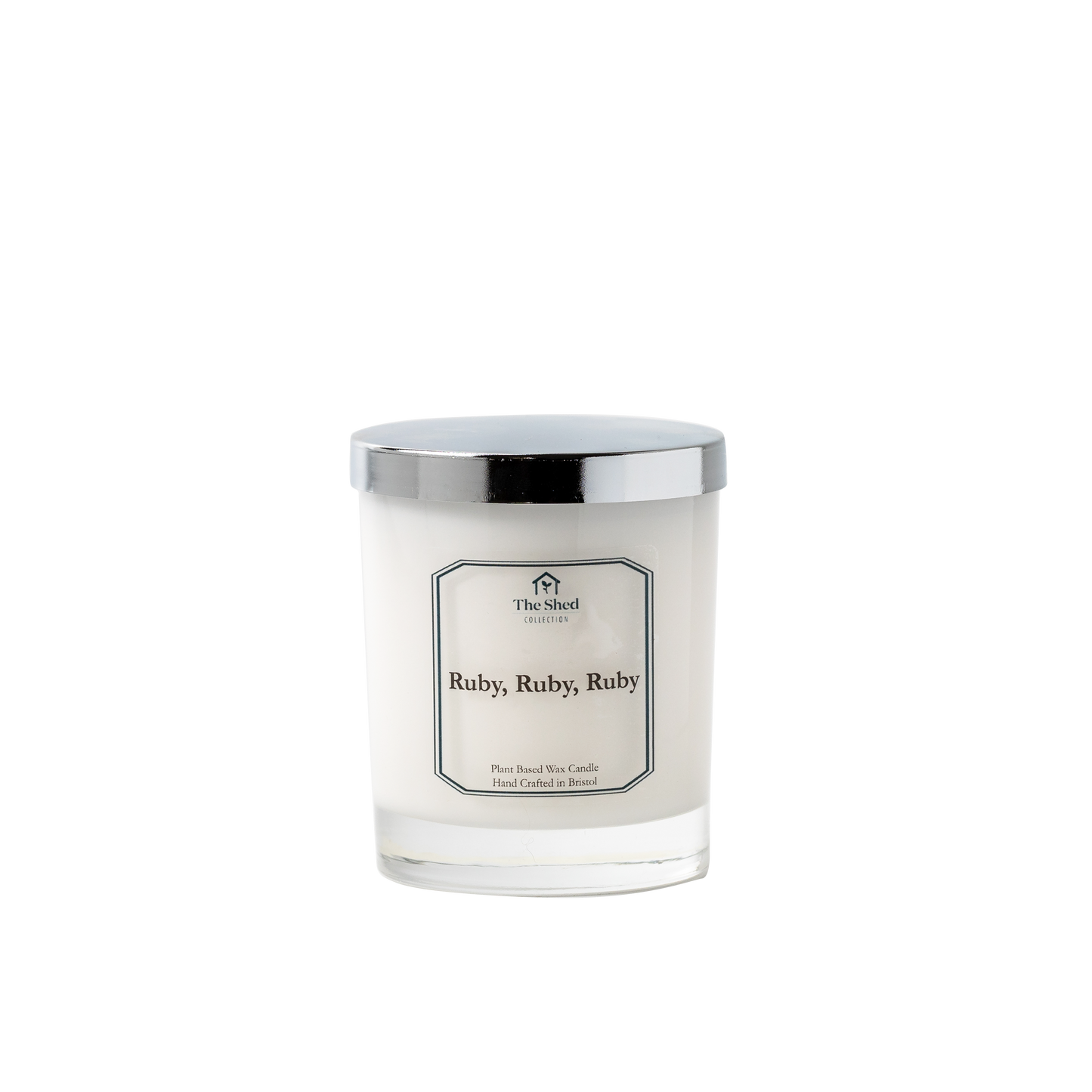 White cylindrical candle container with silver lid label shows Ruby Ruby Ruby