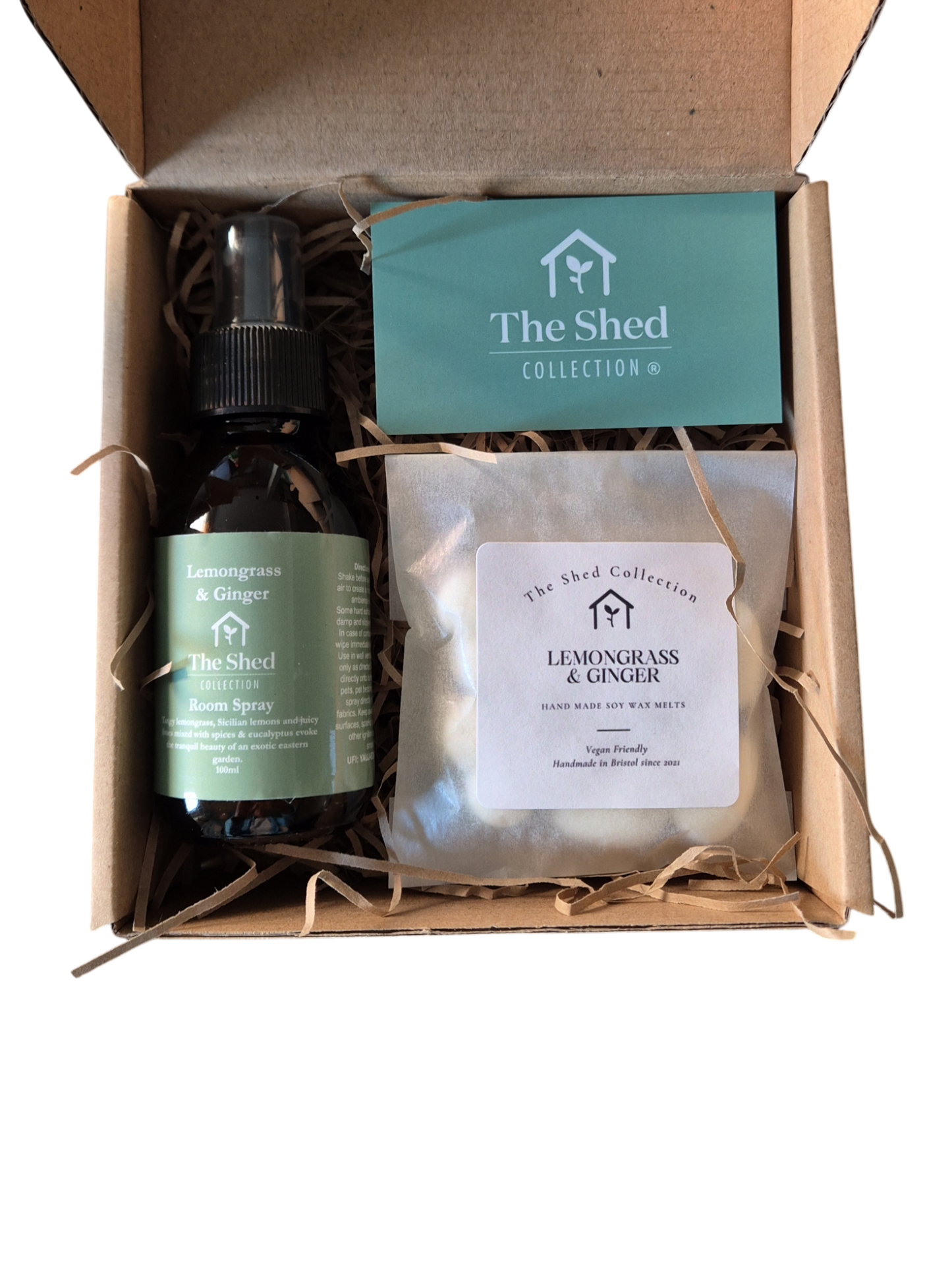 A gift set box containing heart-shaped wax melts in a green bottle with a spray nozzle, a white sachet, and a room spray bottle, all branded with 'the shed collection'.