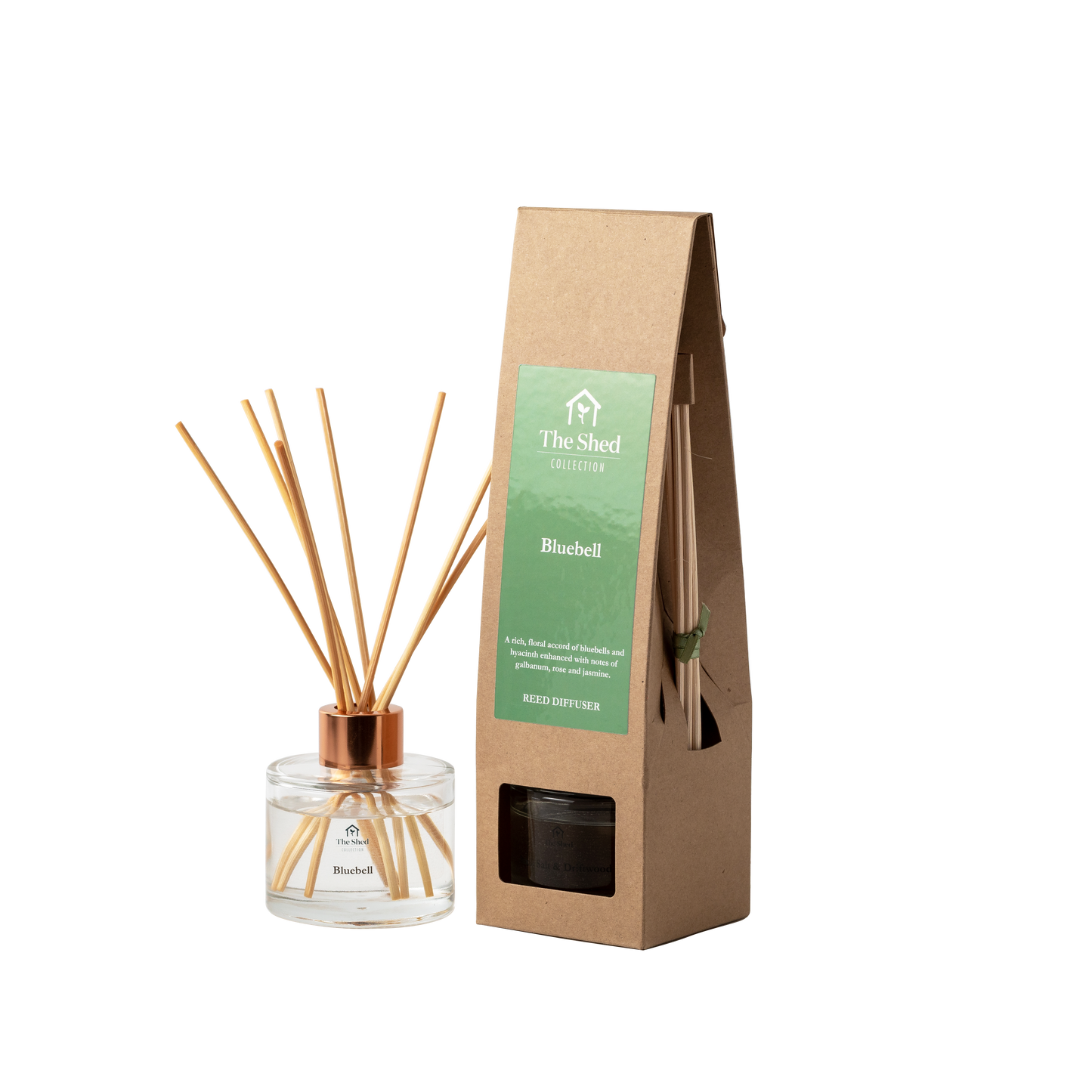 A reed diffuser bottle with reeds and a cap stands next to its brown kraft paper packaging box labeled 'The Shed Collection' and 'Bluebell'.