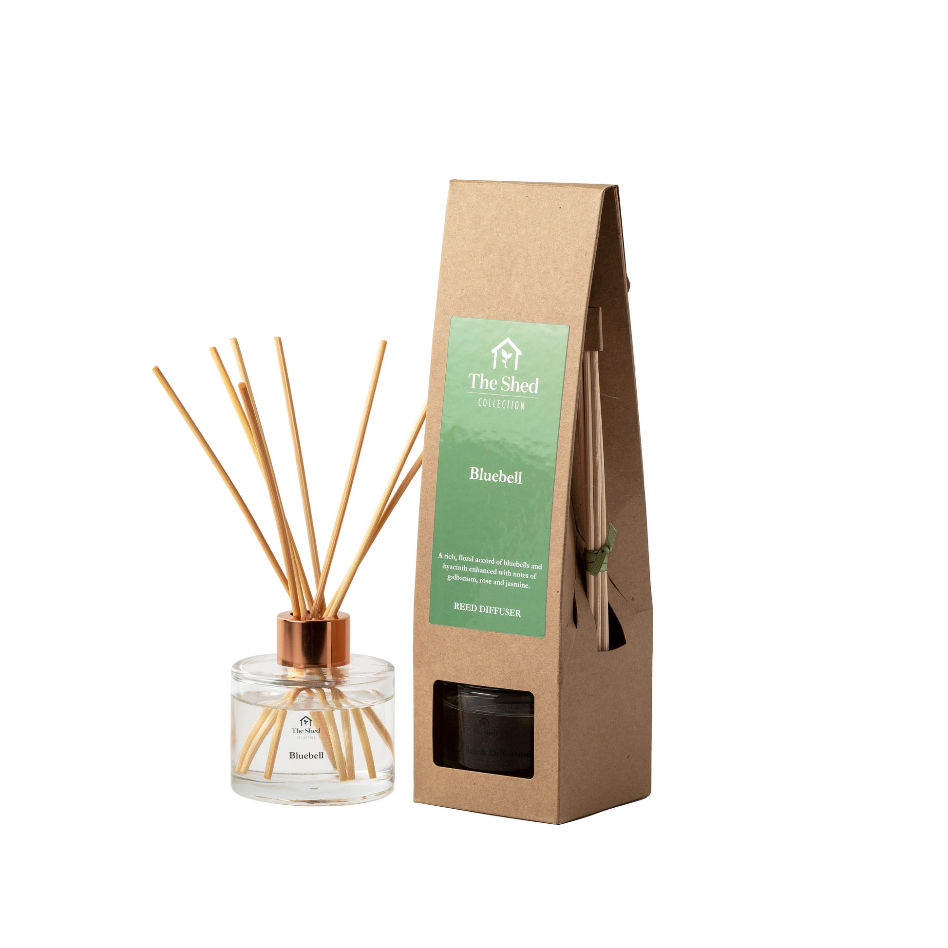 A reed diffuser bottle with reeds and a cap stands next to its brown kraft paper packaging box labeled 'The Shed Collection' and 'Bluebell'.