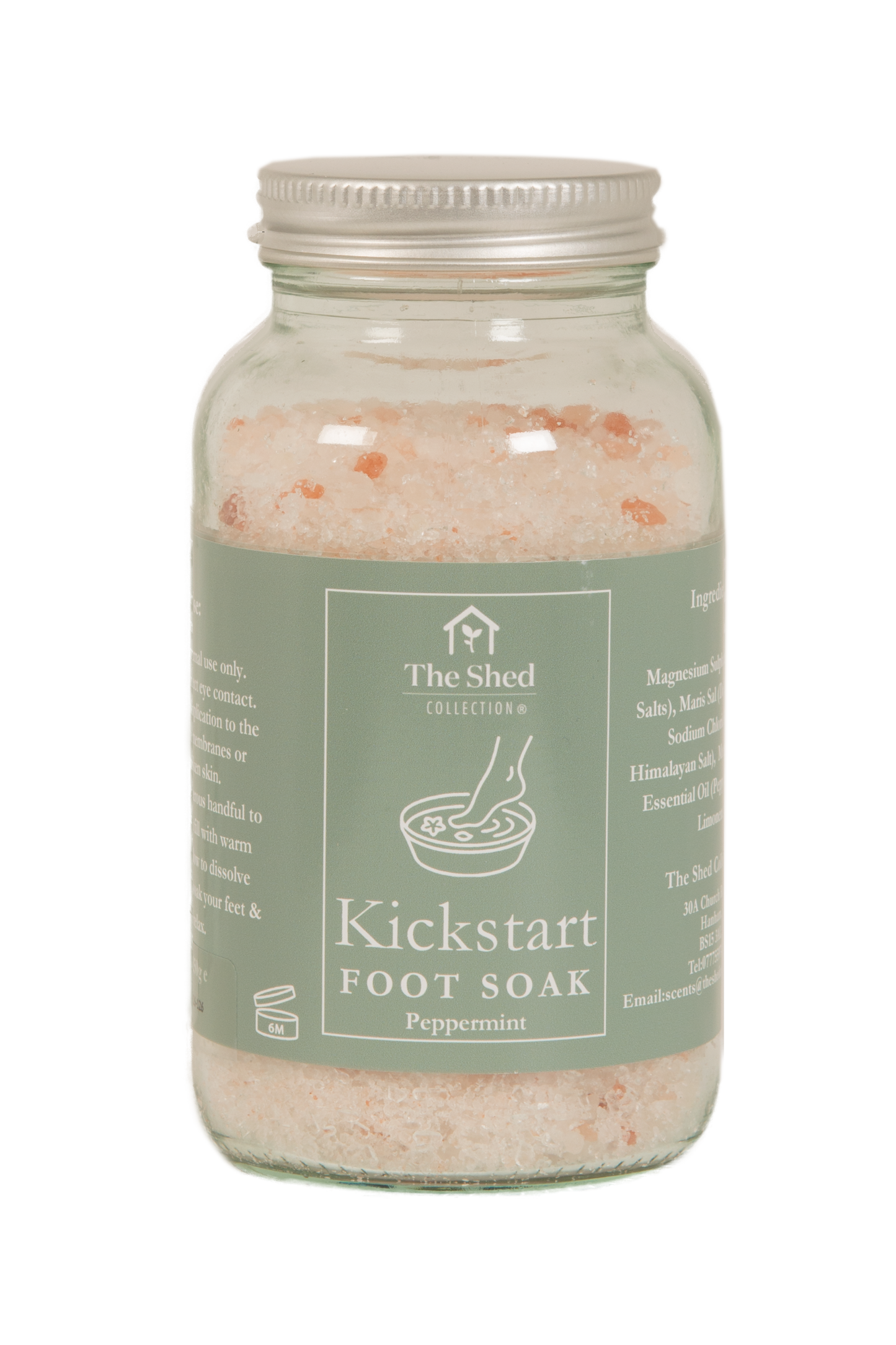 A glass jar of foot soak salts with a silver metal lid and a sage green label reading 'Kickstart FOOT SOAK Peppermint' by The Shed Collection, shown on a white background.