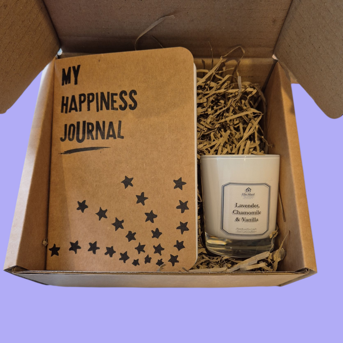 Box containing 'My Happiness Journal' and a candle labeled 'Lavender, Chamomile & Vanilla'.