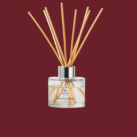 The Shed Collection Ruby Ruby Ruby Reed Diffuser on a deep red background. 