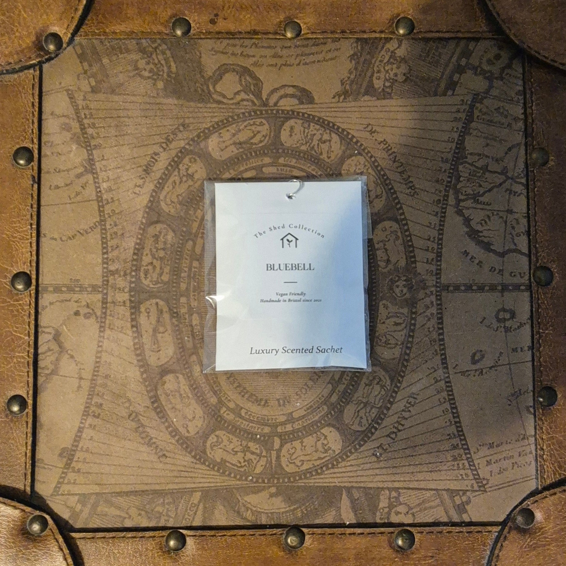 Scented sachet on a decorative wooden surface with map design